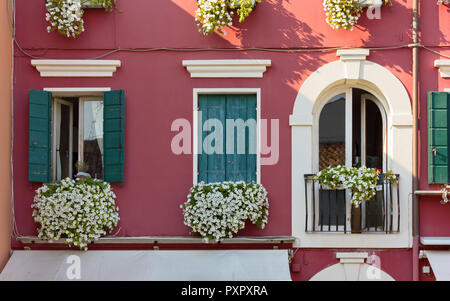 Facade of a traditional building in the venetian style decorated with flowers Stock Photo