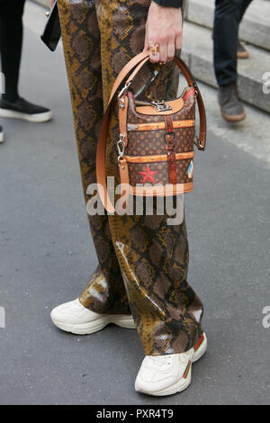 MILAN, ITALY - SEPTEMBER 22, 2018: Woman with Louis Vuitton skirt and brown orange  shirt looking at phone before Simonetta Ravizza fashion show, Milan Stock  Photo - Alamy