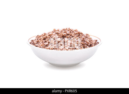 Buckwheat boiled in white deep plate. Isolated on white background. Stock Photo