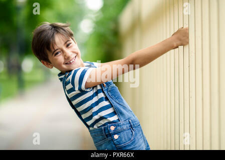 Portrait of smiling little girl playing outdoors Stock Photo