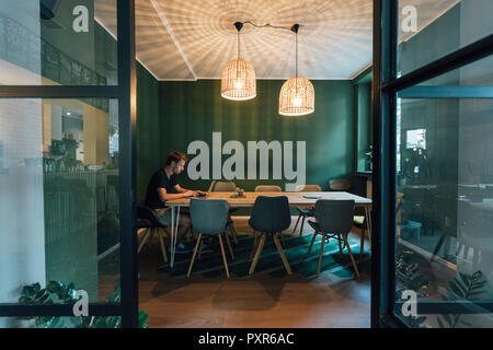 Man working overtime in his own start up business Stock Photo