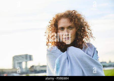 Germany, Cologne, portrait of freckled young woman Stock Photo