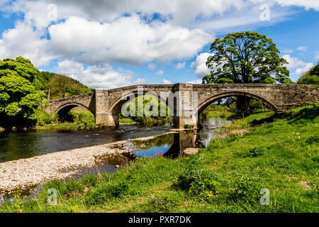 Barden Bridge carrying the road towards Appletreewick over the river Wharf near Barden Tower in the Yorkshire Dales Stock Photo