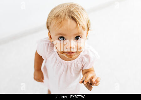Portrait of little girl eating chocolate cookie Stock Photo