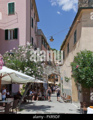 Tourists explore the oleander-lined lanes of Monterosso al Mare,  a town and comune in the province of La Spezia, part of the region of Liguria. It is Stock Photo
