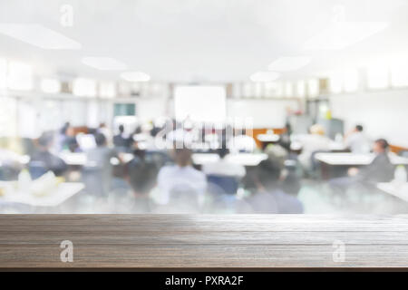 Wood Table Top Background on blurred people lecture in seminar room education or meetting concept ,abstract blur people background Stock Photo
