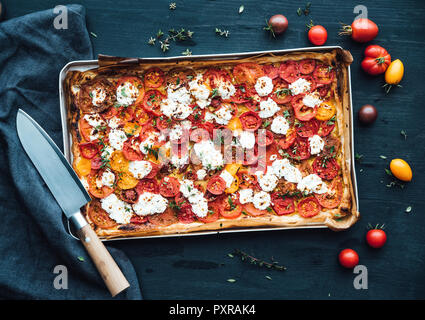 Tomato tart with goat cheese and thyme on mustard Stock Photo