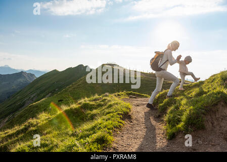 Germany, Bavaria, Oberstdorf, mother and little daughter on a hiking trip in the mountains Stock Photo