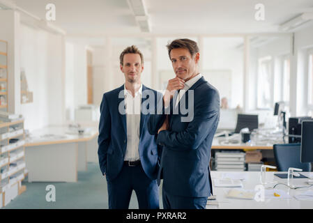 Portrait of two successful businessmen in their office Stock Photo