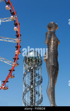 Georgia, Adjara, Batumi, Miracle Park, Alphabetic Tower and ferris wheel with Alin and Nino sculpture in foreground Stock Photo
