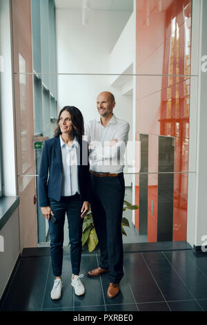 Portrait of a successful business team, standing in office builging Stock Photo