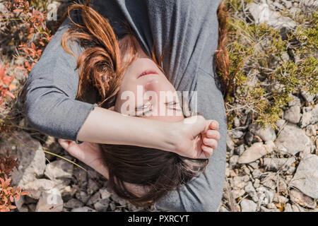 Portrait of daydreaming young woman in nature Stock Photo