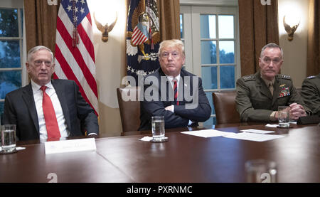 October 23, 2018 - Washington, District of Columbia, U.S. - United States President Donald J. Trump, center, makes a statement to the media as he prepares to receive a briefing from senior military leaders in the Cabinet Room of the White House in Washington, DC on Tuesday, October 23, 2018. The President took questions on the proposed space force, immigration, the caravan and Saudi actions in the killing of Jamal Khashoggi. At left is US Secretary of Defense James Mattis and at right is US Marine Corps General Joseph F. Dunford, Chairman of the Joint Chiefs of Staff (Credit Image: © Ron Sa Stock Photo