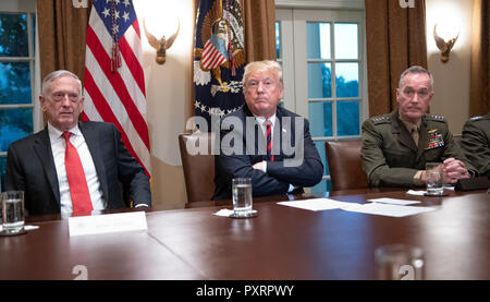 Washington DC, USA. 23rd Oct 2018. United States President Donald J. Trump, center, makes a statement to the media as he prepares to receive a briefing from senior military leaders in the Cabinet Room of the White House in Washington, DC on Tuesday, October 23, 2018.  At left is US Secretary of Defense James Mattis and at right is US Marine Corps General Joseph F. Dunford, Chairman of the Joint Chiefs of Staff. Credit: MediaPunch Inc/Alamy Live News Stock Photo