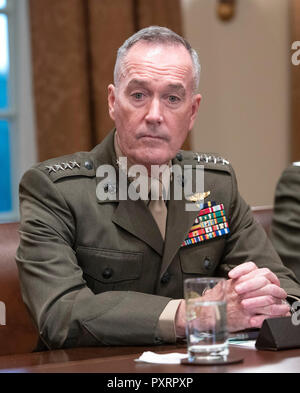Washington DC, USA. 23rd Oct 2018. United States Marine Corps General Joseph F. Dunford, Chairman of the Joint Chiefs of Staff listens as US President Donald J. Trump makes a statement to the media as he prepares to receive a briefing from senior military leaders in the Cabinet Room of the White House in Washington, DC on Tuesday, October 23, 2018. The President took questions on the proposed space force, immigration, the caravan and Saudi actions in the killing of Jamal Khashoggi. Credit: MediaPunch Inc/Alamy Live News Stock Photo