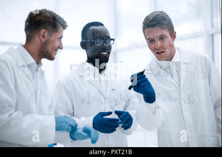 promising scientist makes notes on the Board Stock Photo