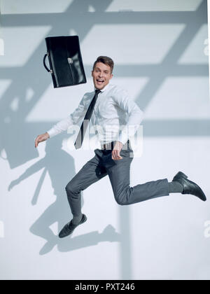 business man jumping in the air with a large smile on his face Stock Photo