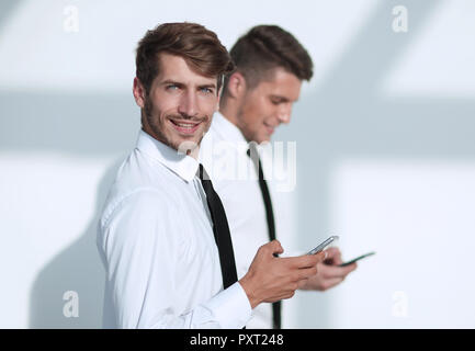 Businessmans holding mobile phone Stock Photo