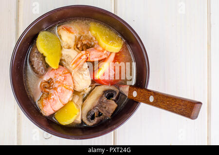 Asian cuisine. Soup with shrimps, mushrooms, chicken, ginger. Studio Photo Stock Photo