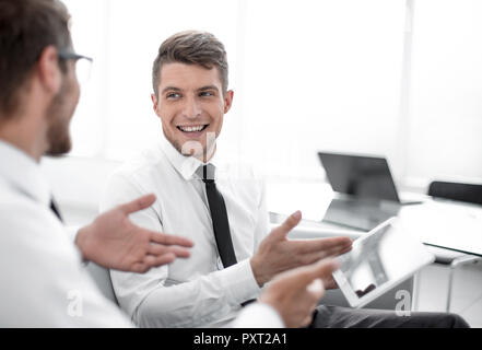 Team of two businessmen discussing new project using tablet and  Stock Photo