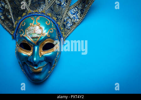 Blue Mardi Gras or carnival jester mask on a blue background Stock Photo