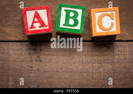 Colorful wooden letter blocks making the on brown wood background Stock Photo