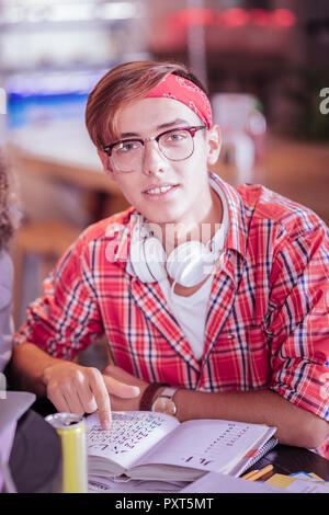 Positive delighted young man looking straight at camera Stock Photo