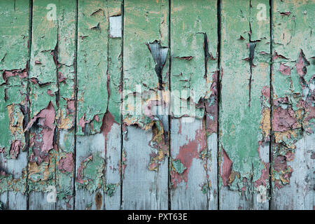Peeling green and red paint on wooden wall, Russian miners settlement Barentsburg, Isfjorden, Spitsbergen Stock Photo