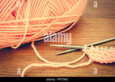 beige yarns and knitting needles. Toned image. Stock Photo