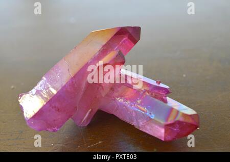 Beautiful Pink Aura Quartz Cluster, Vibrant colored healing crystal specimen in natural light. Rainbow sparkly crystal cluster. Pink healing crystal. Stock Photo