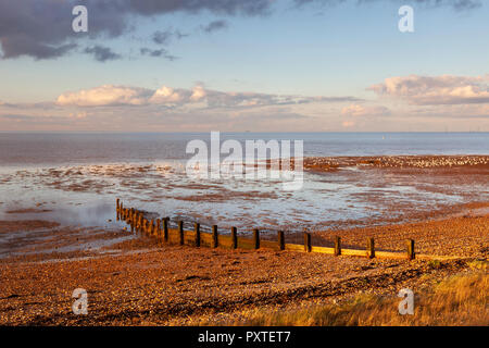 Bright light just before sunset during February on the shingle beach at Seasalter, near Whitstable on the north Kent coast, UK. Stock Photo