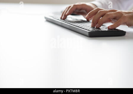 Businessman or programmer typing on black computer keyboard. With copy space. Stock Photo