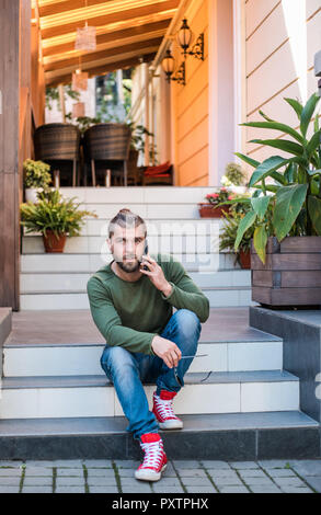 Handsome stylish man is talking by phone. Stock Photo