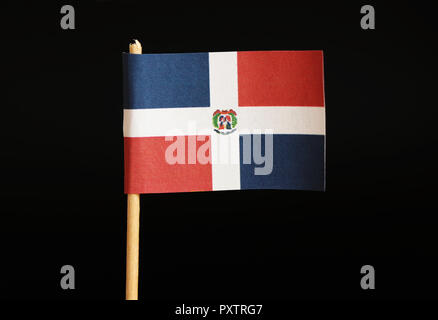 A official flag of dominican republic on toothpick on black background. It is hand flag represented your country. Dominican republic located in centra Stock Photo