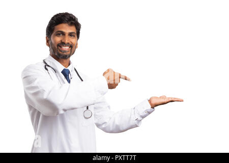 Indian doctor or physician pointing with index finger at copyspace as invisible object in palm isolated on white Stock Photo