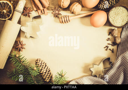 Empty paper for recipe of Christmas baking. Ingredients for Christmas baking. Spices, cutters and tools for cookie. Branch and cones. Top view. Copy s Stock Photo