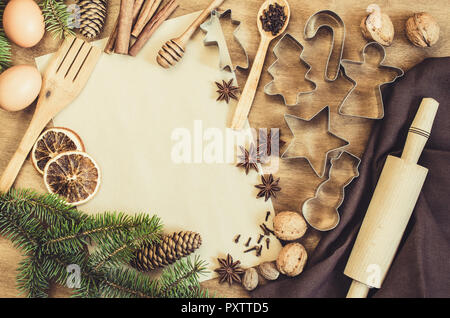 Empty paper for recipe of Christmas baking. Ingredients for Christmas baking. Spices, cutters and tools for cookie. Branch and cones. Top view. Copy s Stock Photo