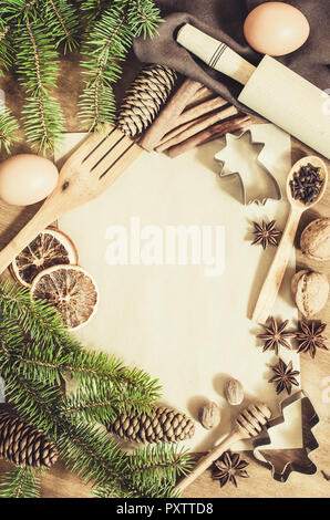 Empty paper for recipe of Christmas baking. Ingredients for Christmas baking. Spices, cutters and tools for cookie. Branch and cones. Top view. Copy s Stock Photo