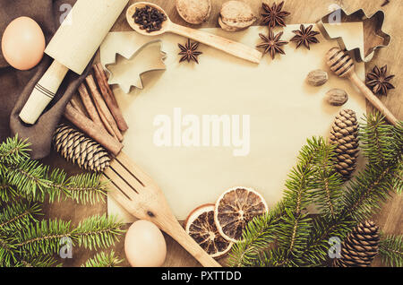 Empty paper for recipe of Christmas baking. Ingredients for Christmas baking. Spices, cutters and tools for cookie. Branch and cones. Top view. Copy s Stock Photo