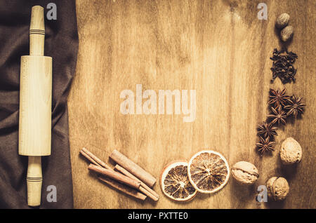 Culinary Background. Spices and tools for Christmas Baking on a Wooden Table. Top view. Copy space. Selective focus. Toned image. Stock Photo