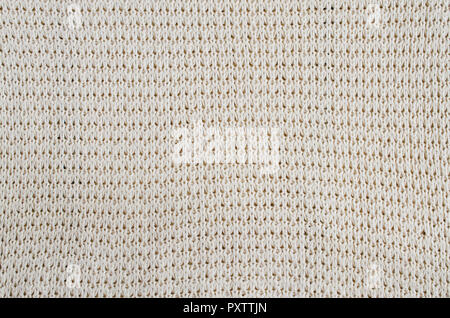 Vintage Beige Knitted Fabric Texture. Crochet Warm Woolen Yarn Background. Close-up. Selective focus. Stock Photo