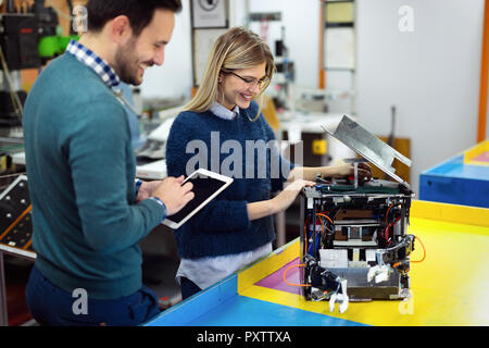 Young attractive students of mechatronics working on project Stock Photo
