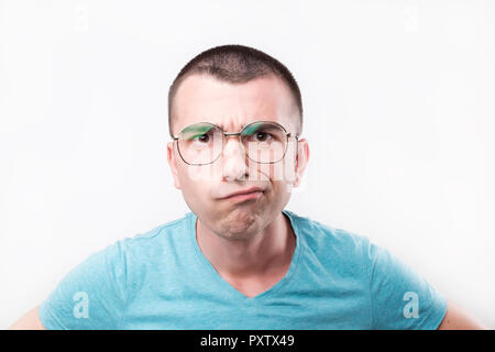 Young handsome man in glasses thinking in doubts and touching lips on gray. Stock Photo