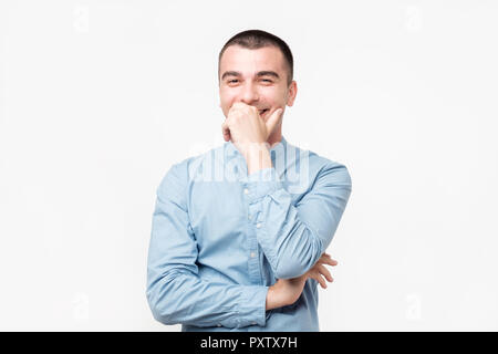 Hispanic young man with laugh face on grey background. Stock Photo