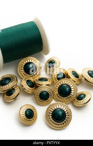 Fancy Green and Gold Sewing Buttons with Green Thread Stock Photo
