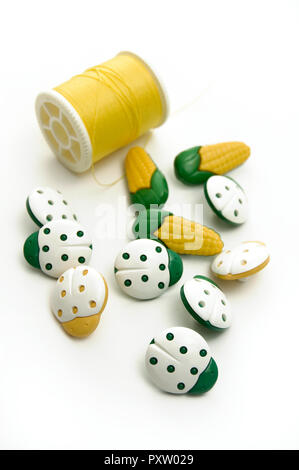 Green and Yellow LadyBug, Corn on the Cob Sewing Buttons with Yellow Thread Stock Photo
