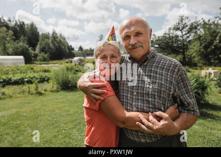 Portrait of senior couple embracing each other in the garden Stock Photo