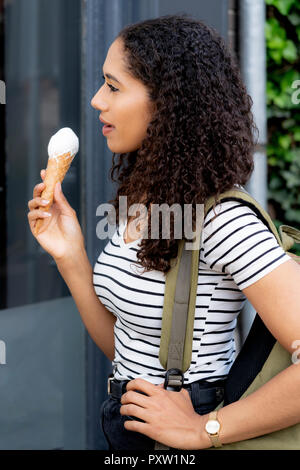 Woman eating ice cream in the city Stock Photo