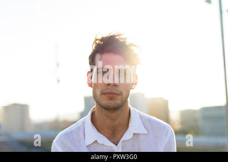 Portrait of handsome young man outdoors at sunset Stock Photo