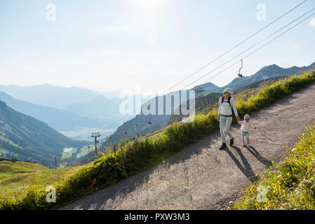 Germany, Bavaria, Oberstdorf, mother and little daughter on a hiking trip in the mountains Stock Photo